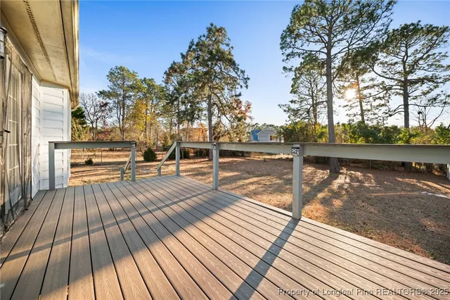 a view of a balcony with wooden floor and outdoor space