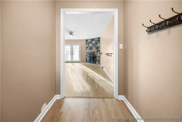 a view of a room with wooden floor and a window