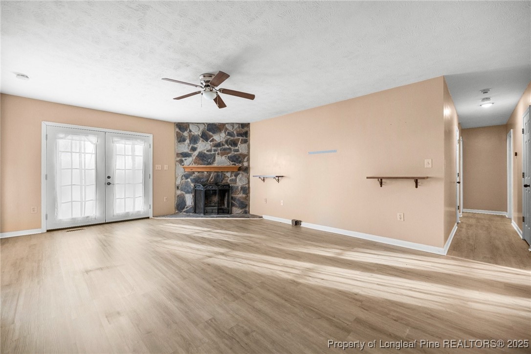 109 Ashton Place Spring Lake, NC 28390 - Photo 4 of 20 an empty room with wooden floor and windows