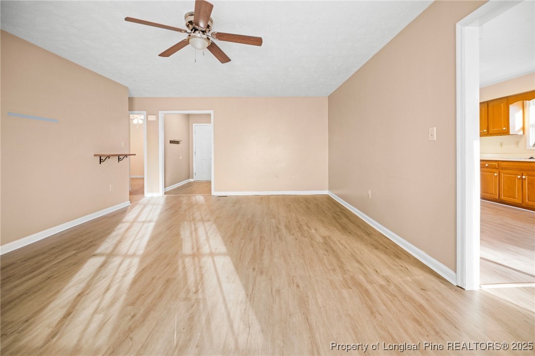109 Ashton Place Spring Lake, NC 28390 - Photo 6 of 20 a view of a room with wooden floor and a ceiling fan