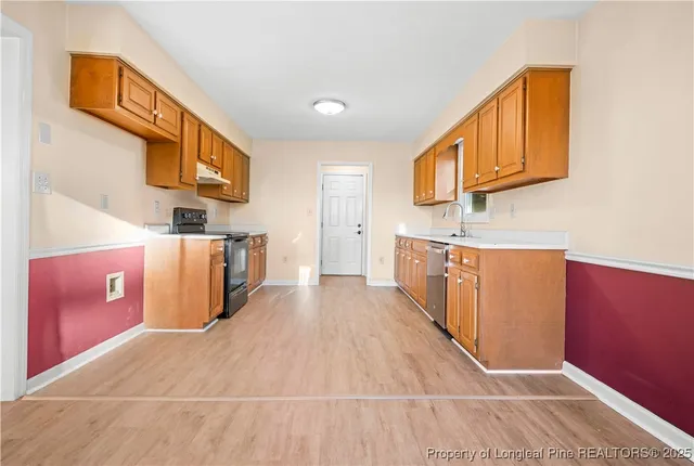a view of a kitchen with furniture and wooden floor