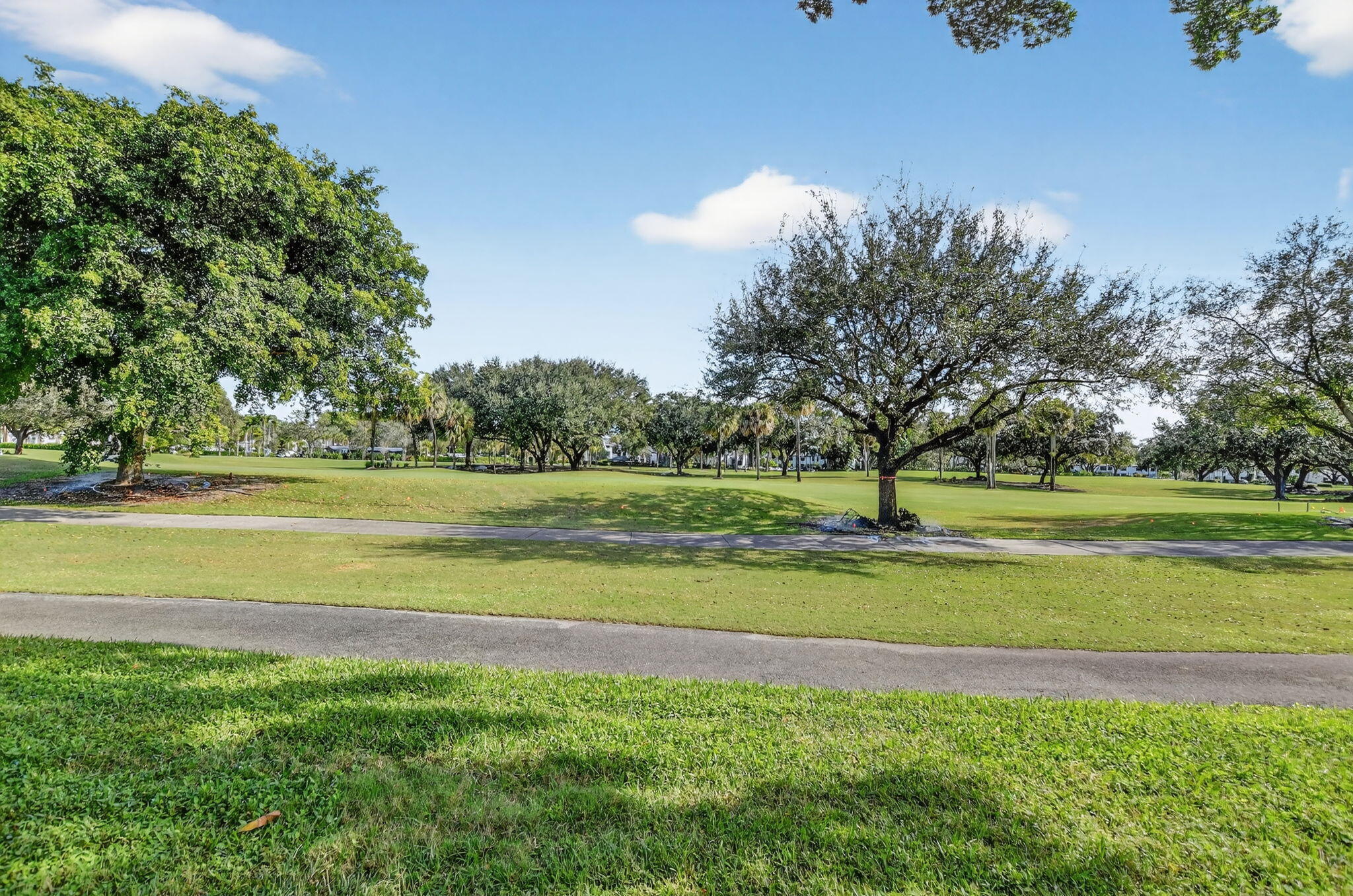 2306 Bridgewood Drive Boca Raton, FL 33434 - Photo 40 of 66 a view of a golf course with a lake view
