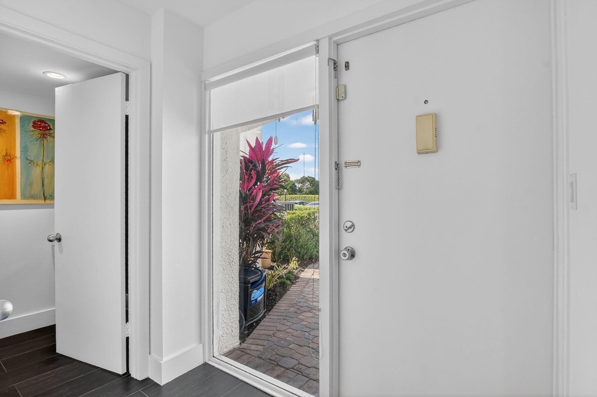 2306 Bridgewood Drive Boca Raton, FL 33434 - Photo 6 of 66 a view of a hallway with paintings on the wall