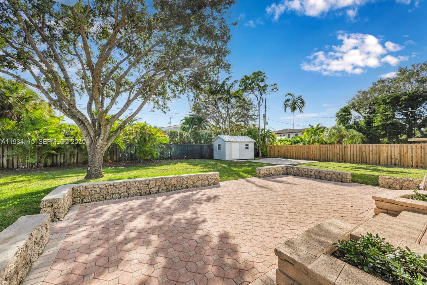 6110 Southwest 79th Street South Miami, FL 33143 - Photo 12 of 22 a view of a house with a yard and a garden