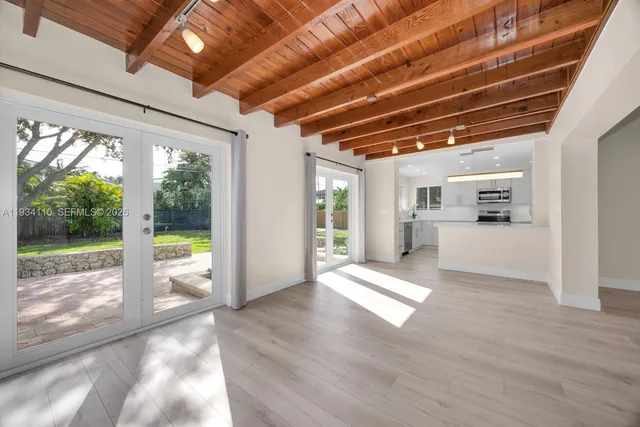 a kitchen with a sink a counter top space stainless steel appliances and cabinets