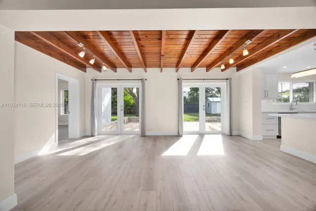a front view of a house with a garden and tree