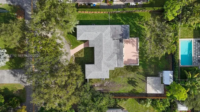 a house view with swimming pool in front of it