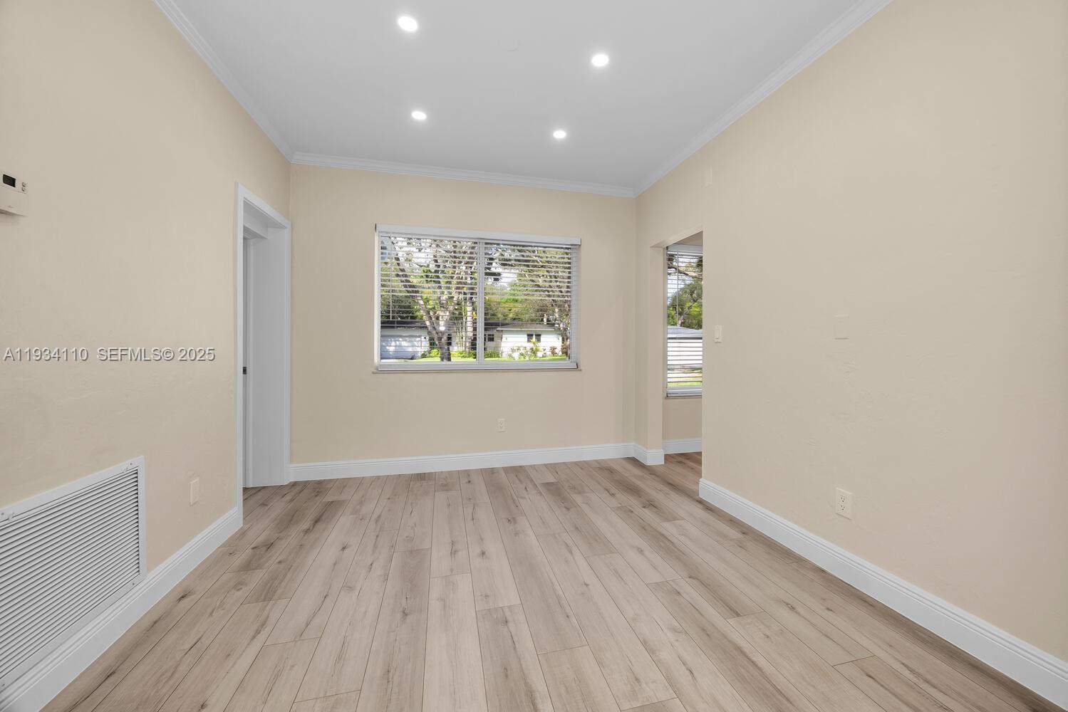 6110 Southwest 79th Street South Miami, FL 33143 - Photo 6 of 22 wooden floor in an empty room with a window