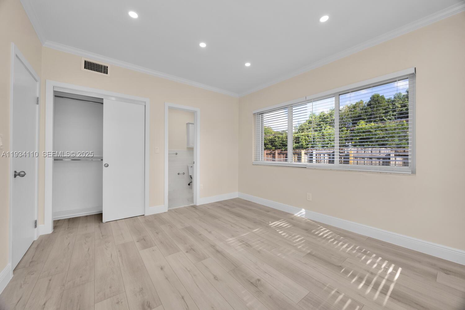 6110 Southwest 79th Street South Miami, FL 33143 - Photo 9 of 22 a view of an empty room with a window