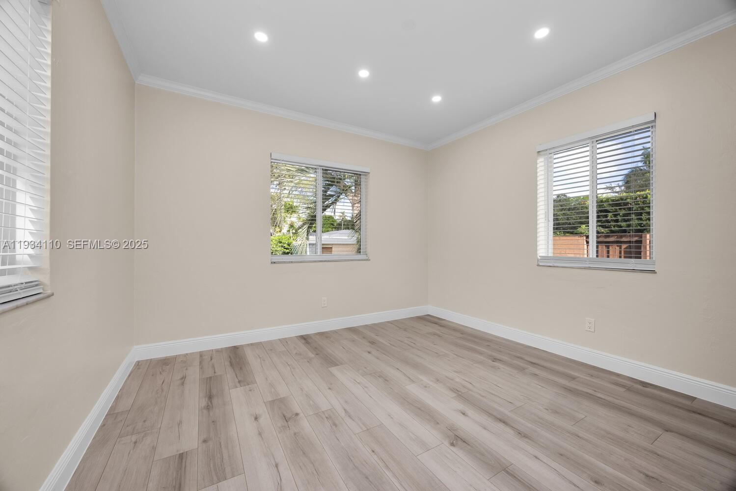 6110 Southwest 79th Street South Miami, FL 33143 - Photo 10 of 22 a view of empty room with wooden floor and fan