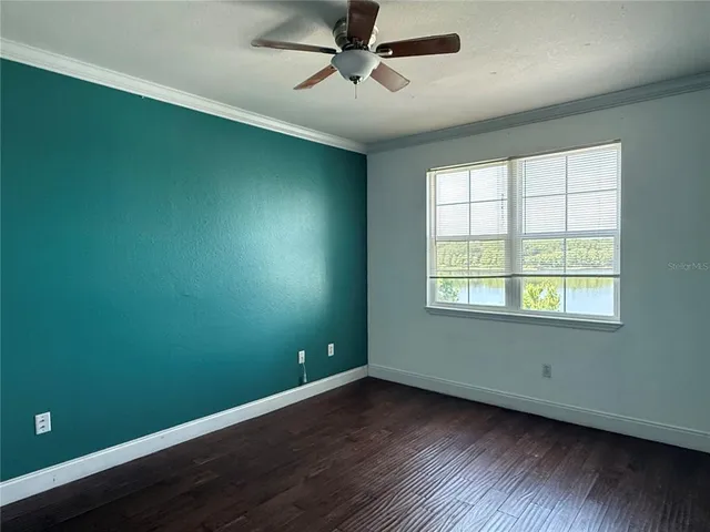 a view of a room with wooden floor and windows