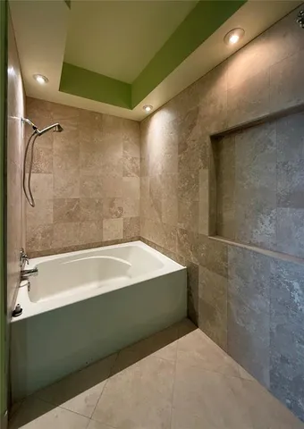 a bathroom with a bathtub and a shower