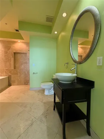 a bathroom with a sink a mirror and a vanity