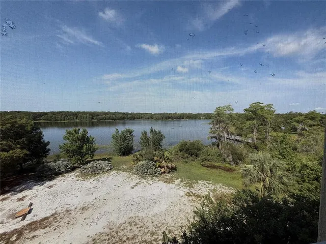 a view of a lake with houses in the back