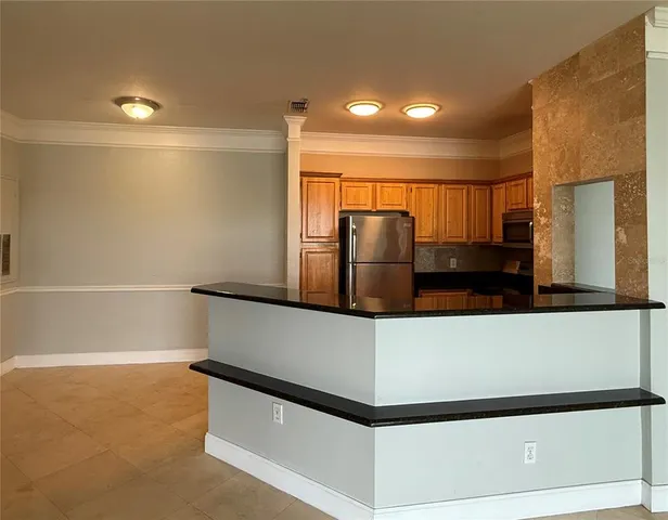 a kitchen with stainless steel appliances a refrigerator and a stove