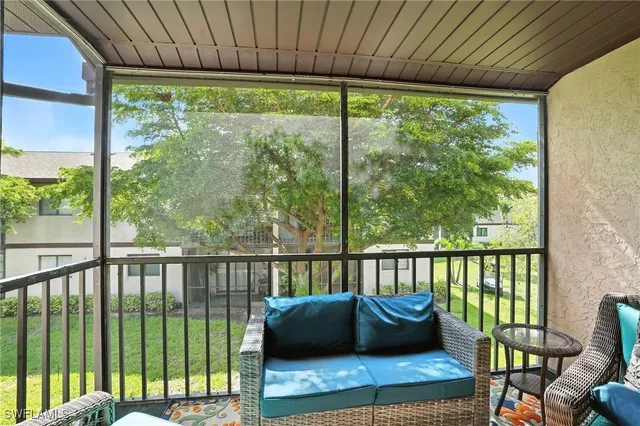 a balcony with couch and outdoor view