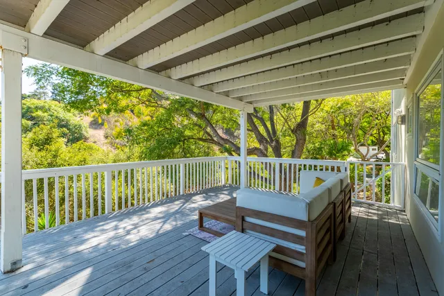 a backyard of a house with outdoor seating