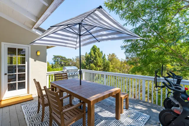 a living room with furniture a chandelier and a floor to ceiling window