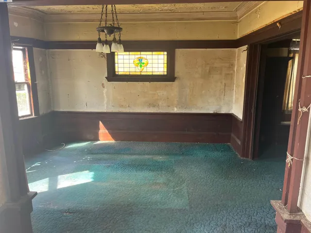 a living room with furniture and large windows