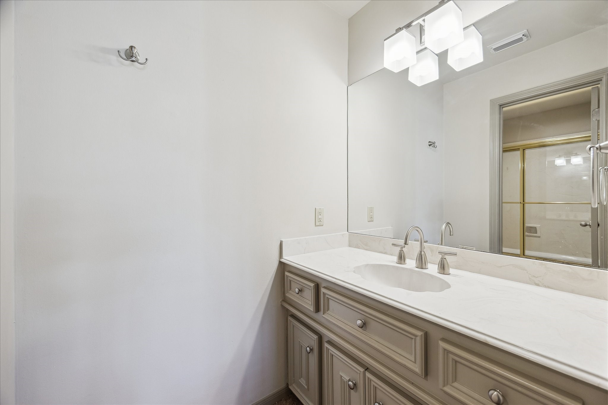 5 Lochtyne Circle Houston, TX 77024 - Photo 29 of 43 a bathroom with a sink a mirror and a light fixture