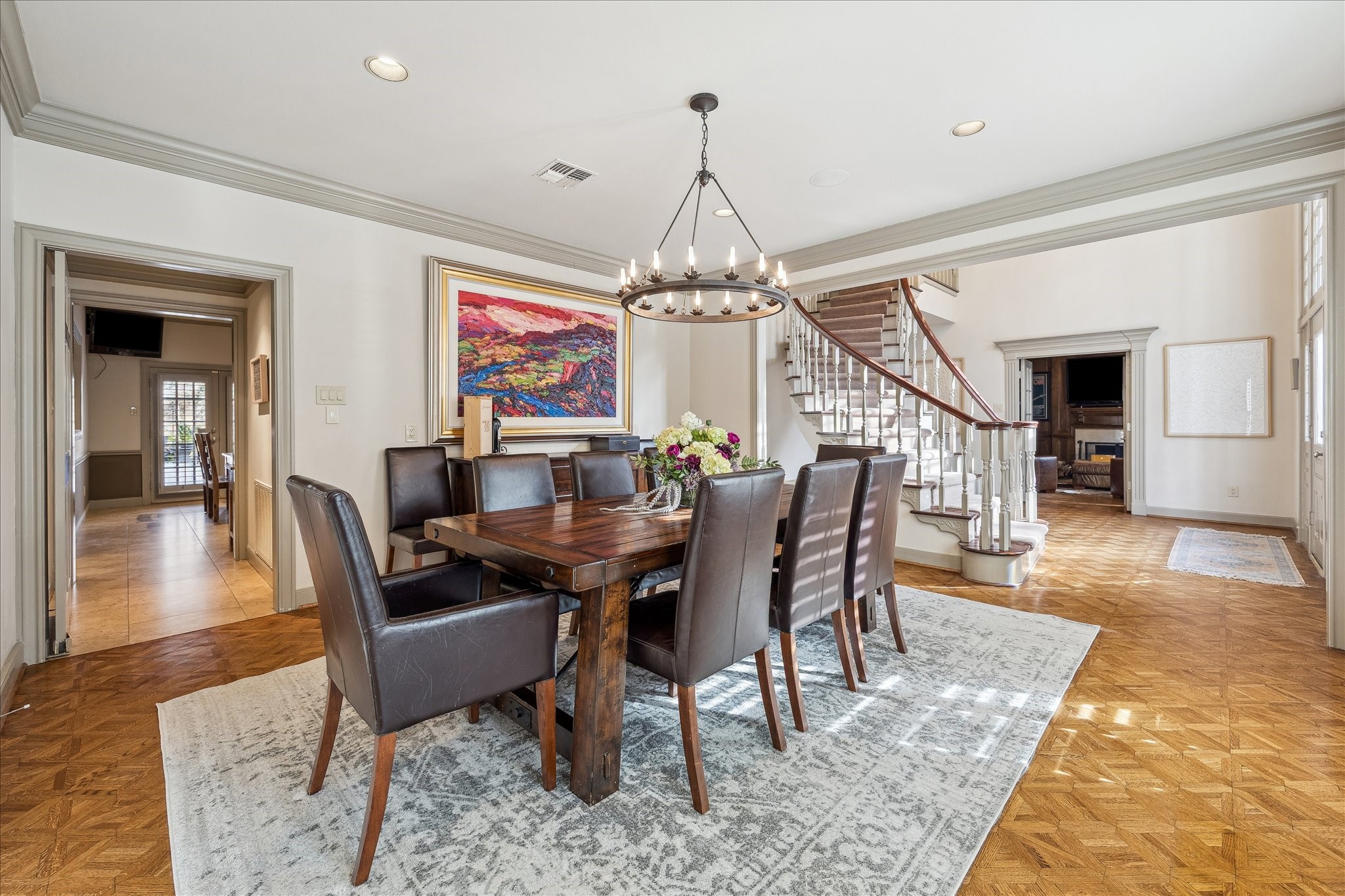 5 Lochtyne Circle Houston, TX 77024 - Photo 7 of 43 a dining room with wooden floor a chandelier a wooden table and chairs