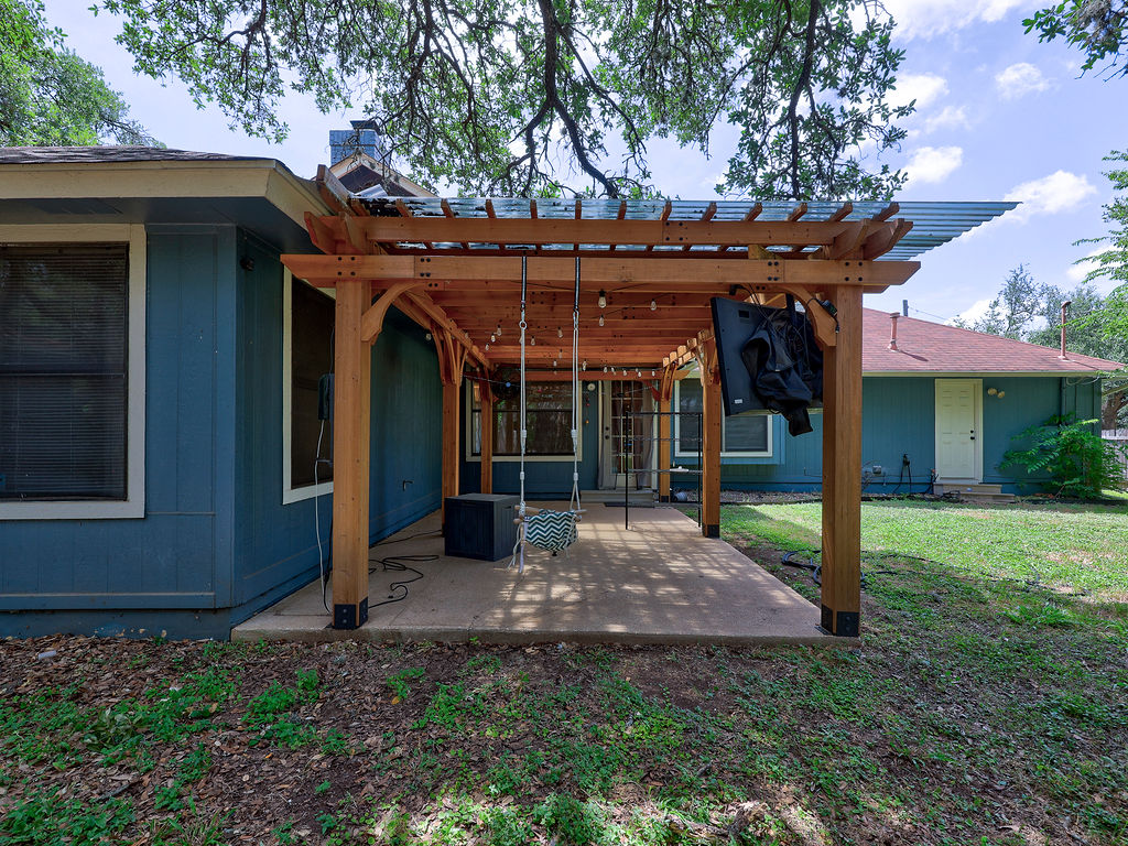 5842 Secrest Drive Austin, TX 78759 - Photo 4 of 40 A charming wooden pergola offers shaded relaxation on this home's inviting patio.