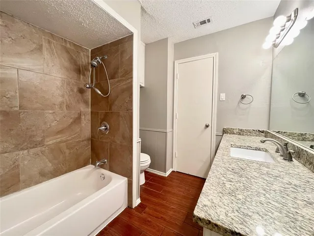 a bathroom with a tub sink and shower