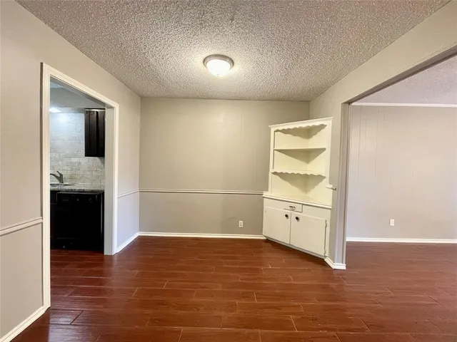 a view of a kitchen with a stove cabinets and wooden floor