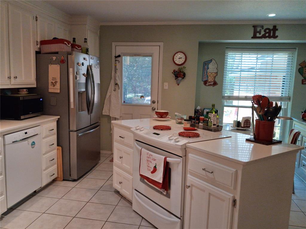 3600 Fox Ridge Road Lorena, TX 76655 - Photo 10 of 31 Kitchen featuring white cabinetry, a stainless steel refrigerator, white tile flooring, and a central island with a built-in range and white countertop