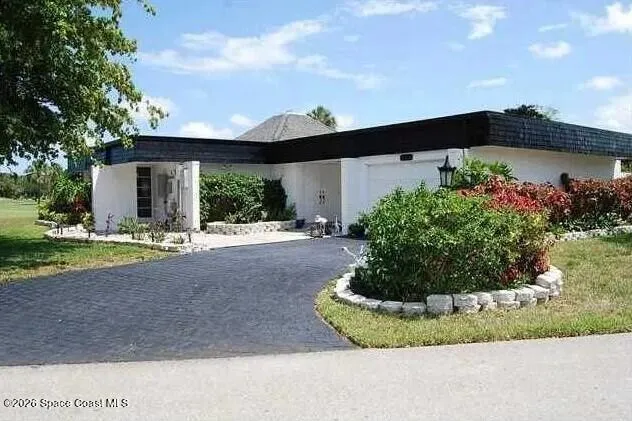 a view of a house with a yard and plants