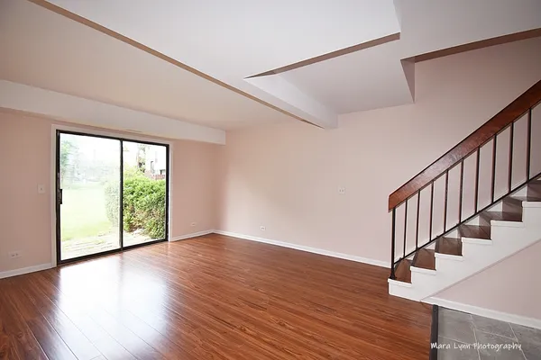 a view of an entryway with wooden floor