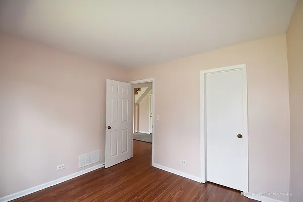 an empty room with wooden floor