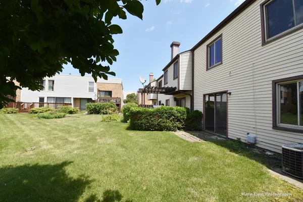 a view of a house with a backyard