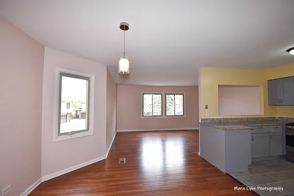a view of a kitchen counter space windows and wooden floor