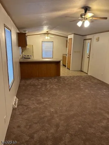 a view of kitchen with a sink and refrigerator