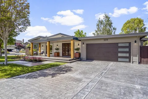 a front view of a house with a yard and a garage