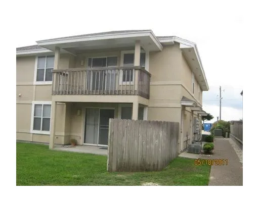 a view of a house with wooden floor and a yard