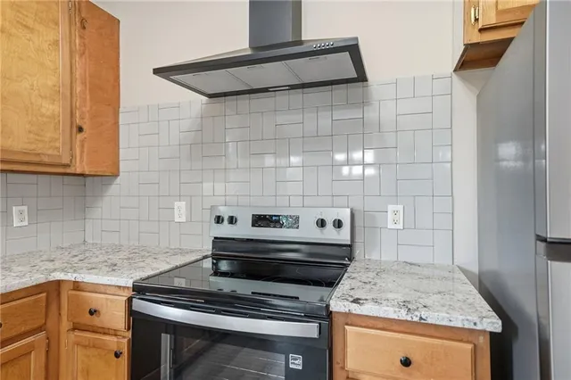 a kitchen with kitchen island wooden floors appliances and cabinets