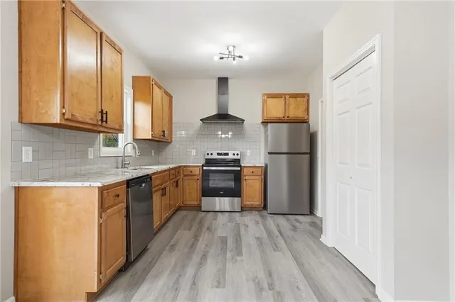a kitchen with a refrigerator stove and a sink