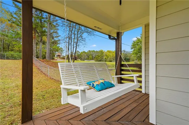 a view of a house with a yard and basketball court