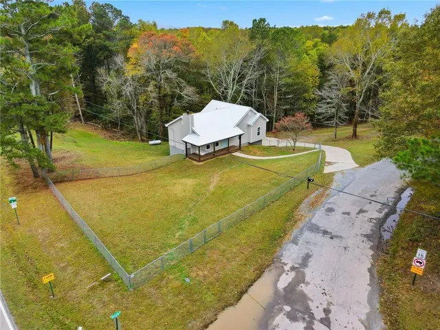 a view of a field of grass and trees