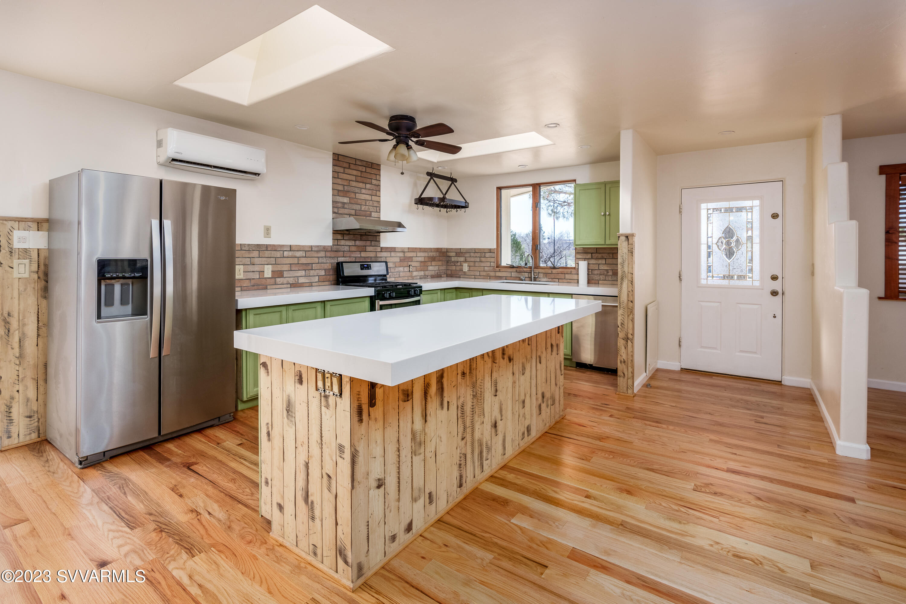 6034 Bice Road Rimrock, AZ 86335 - Photo 21 of 47 a kitchen with stainless steel appliances a kitchen island hardwood floor and a sink