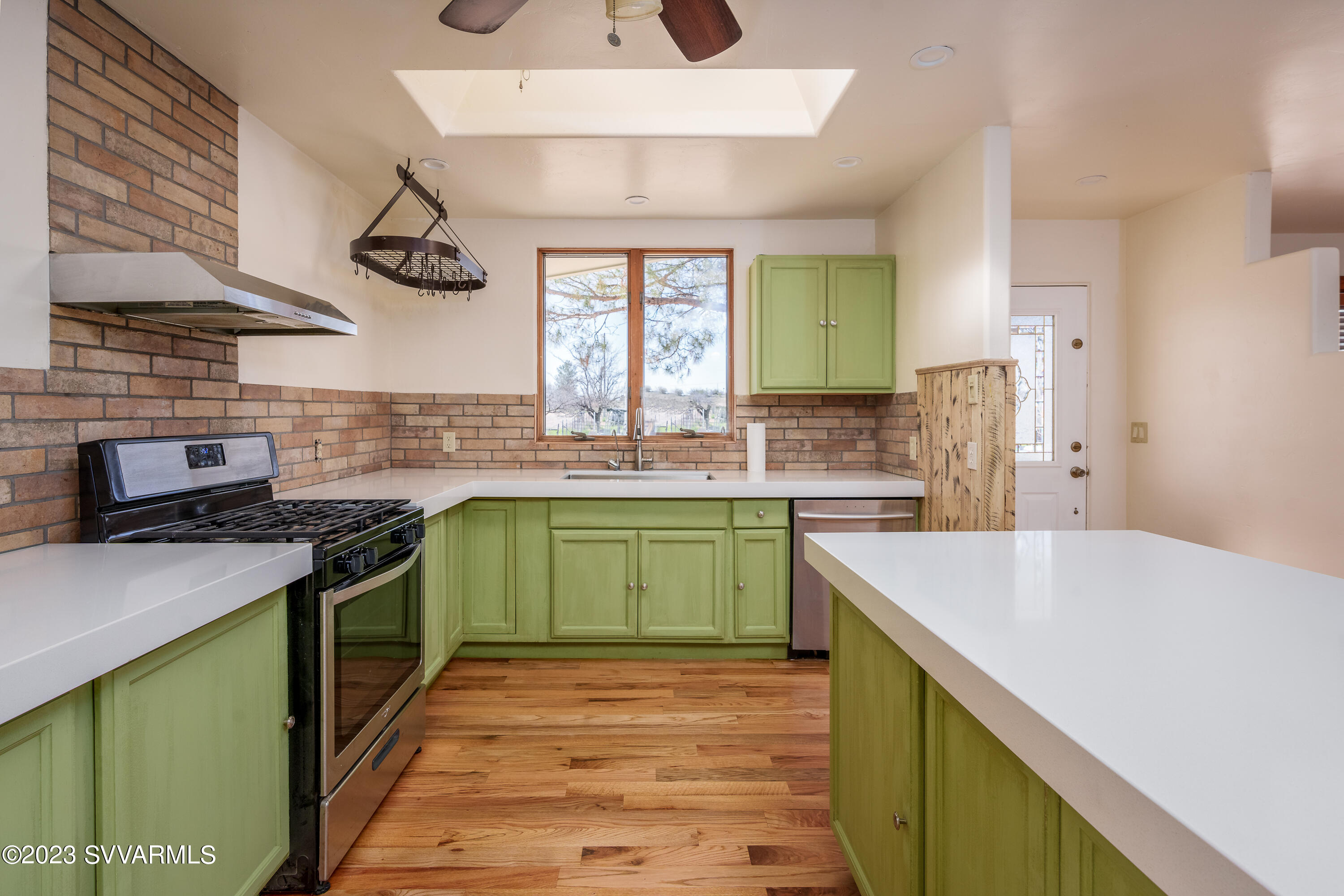 6034 Bice Road Rimrock, AZ 86335 - Photo 22 of 47 a kitchen with a sink and a stove top oven