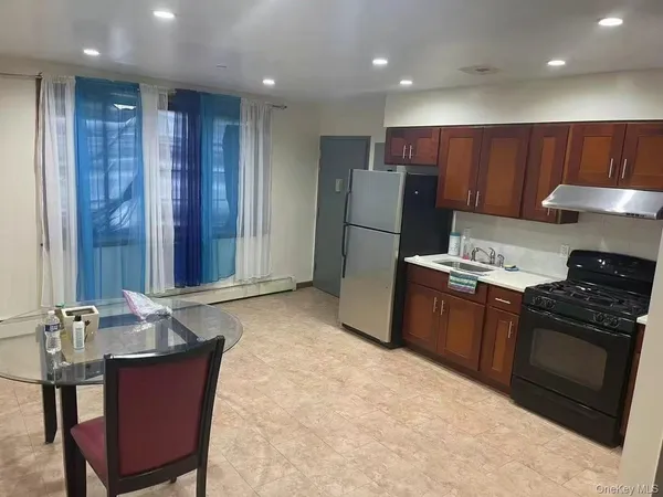 a kitchen with refrigerator and cabinets