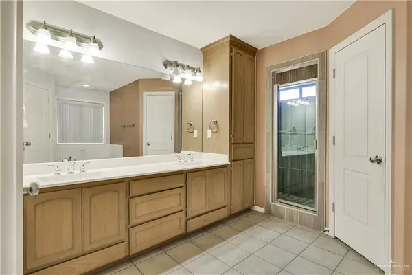 a bathroom with a double vanity sink and a mirror