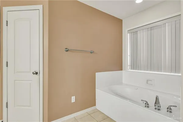 a bathroom with a tub and shower