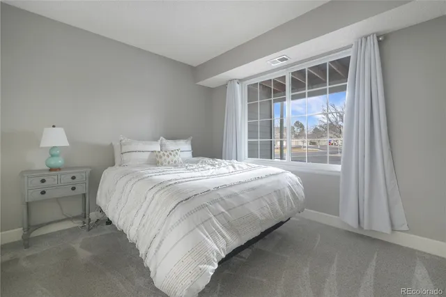 a bedroom with a bed and a night stand