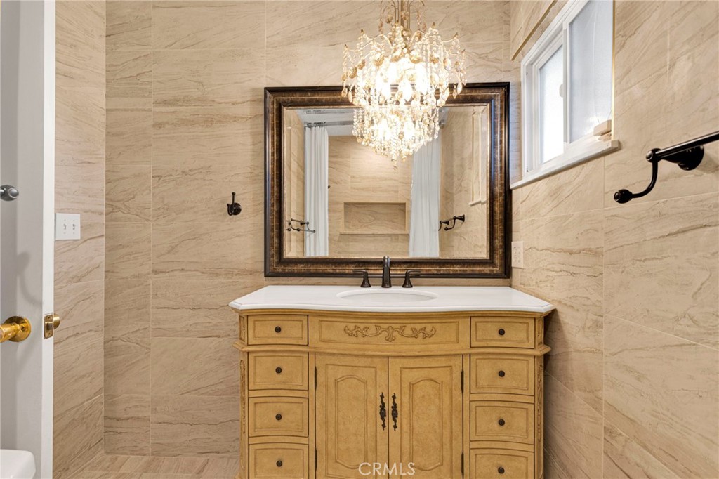 15177 Mendota Road North Apple Valley, CA 92307 - Photo 23 of 50 a bathroom with a granite countertop sink a mirror and a shower