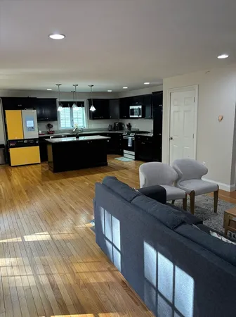 a living room with furniture and kitchen view