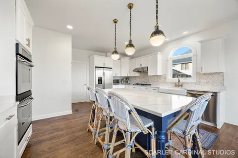 a kitchen with a table and chairs in it